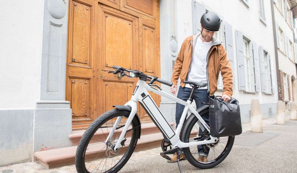 Stromer add-on: Man with his ST3 and Stromer Antwerp carrier bag.