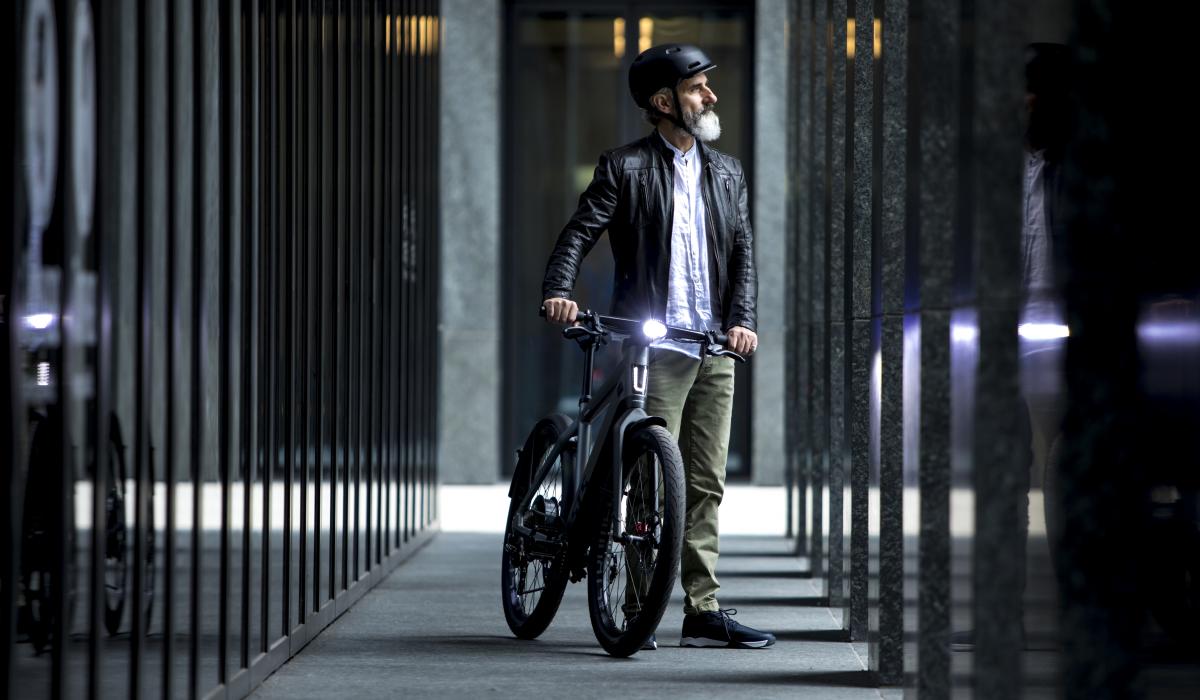 man with stromer bike in front of a building