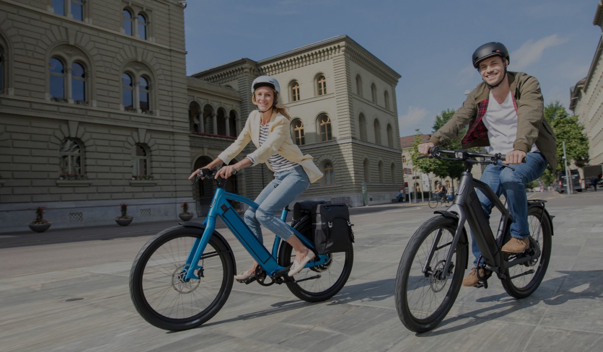 A man and a woman on e-bikes.