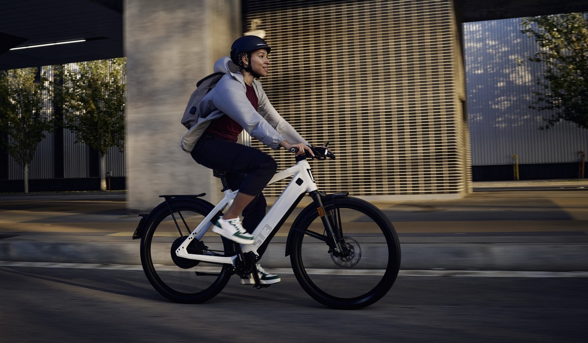 Vrouw op e-bike rijdend door de stad