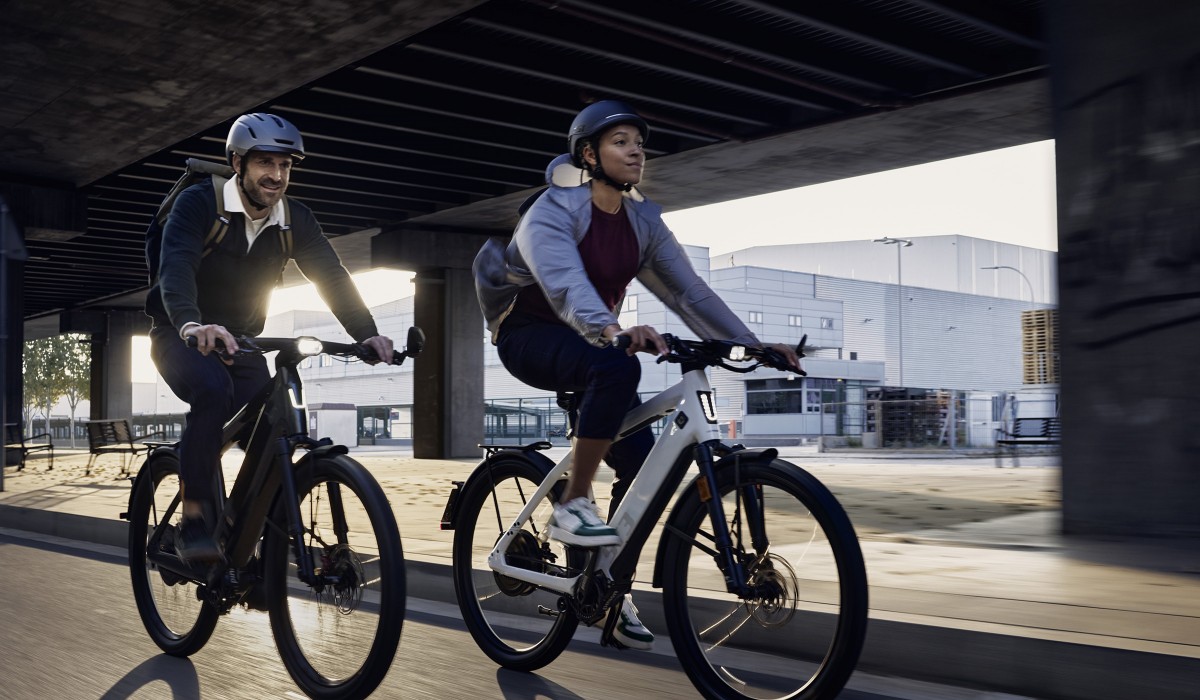 A man and a woman on e-bikes.